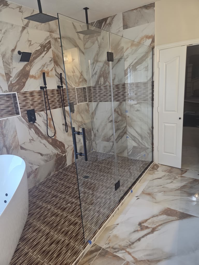 Walk-in marble shower with freestanding soaking tub